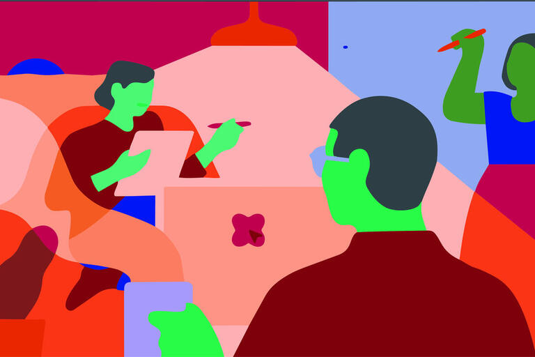 two people talking over a laptop